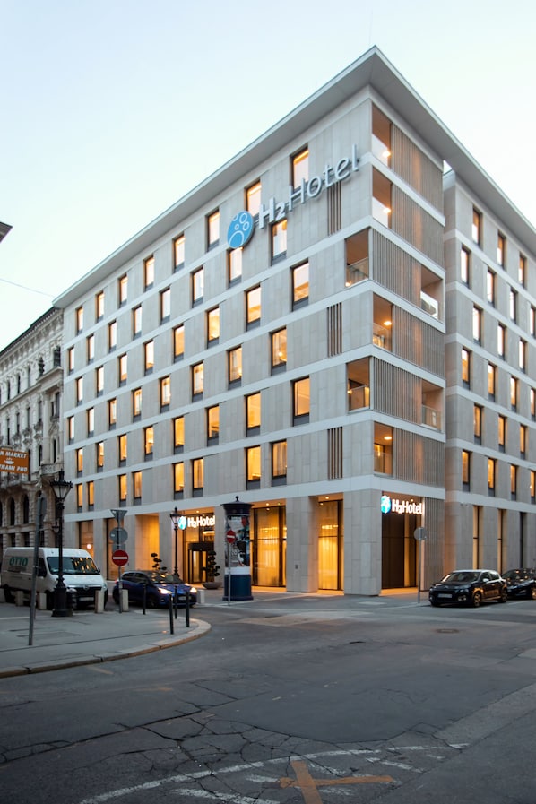 A modern hotel with multiple floors, large windows, and a prominent 'Hotel' sign. - H2 Hotel Budapest (Budapest)