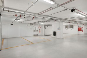 A clean, well-lit indoor space with numbered doors, likely a parking garage or similar facility. - Danubius Hotel District V (Budapest)