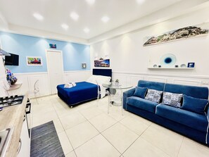 Relax in comfort with a large sofa, matching bed, and flat-screen TV.