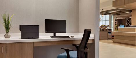 A modern office space with a desk, computer, and office chair.