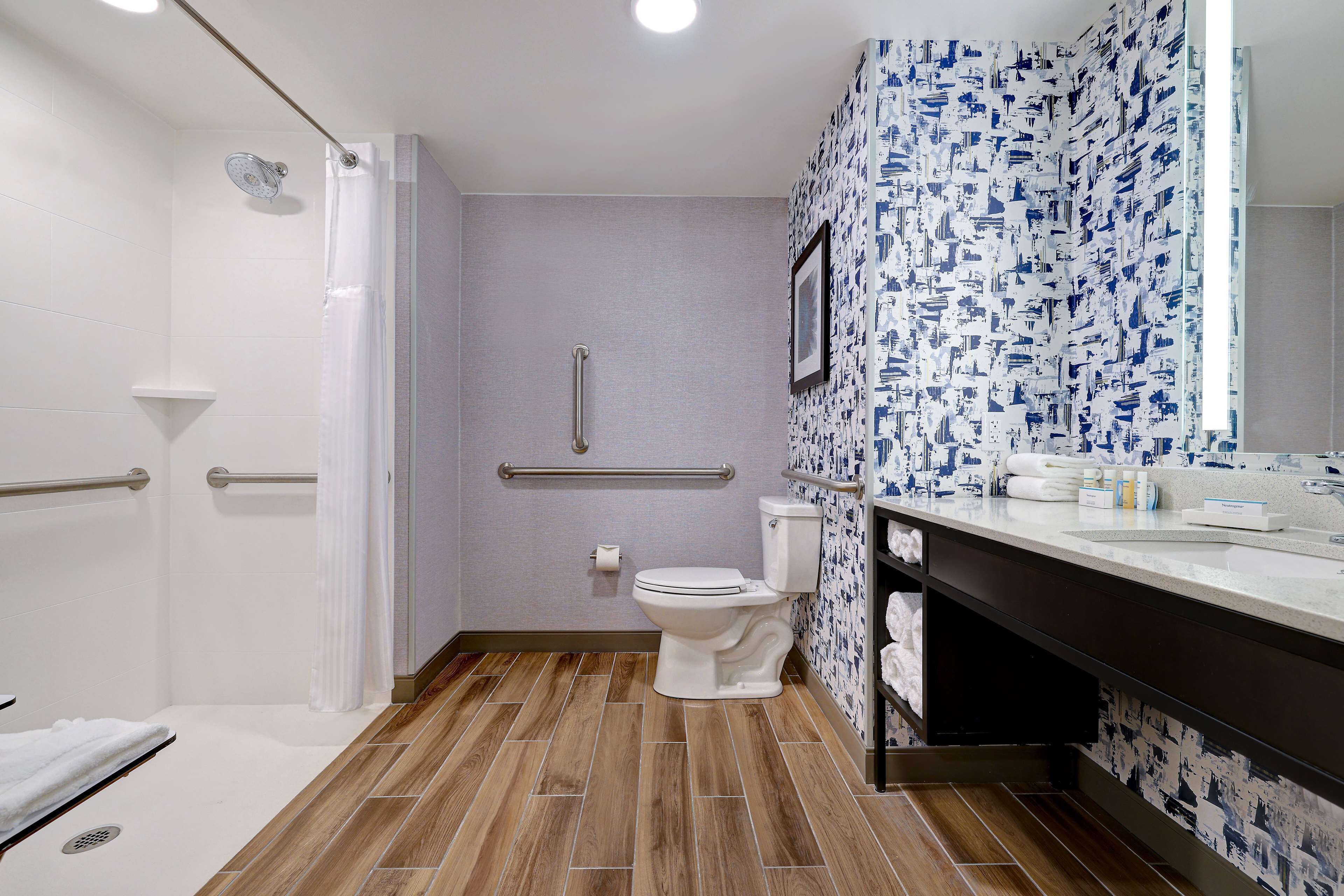 Un bagno moderno con doccia, toilette e lavabo.