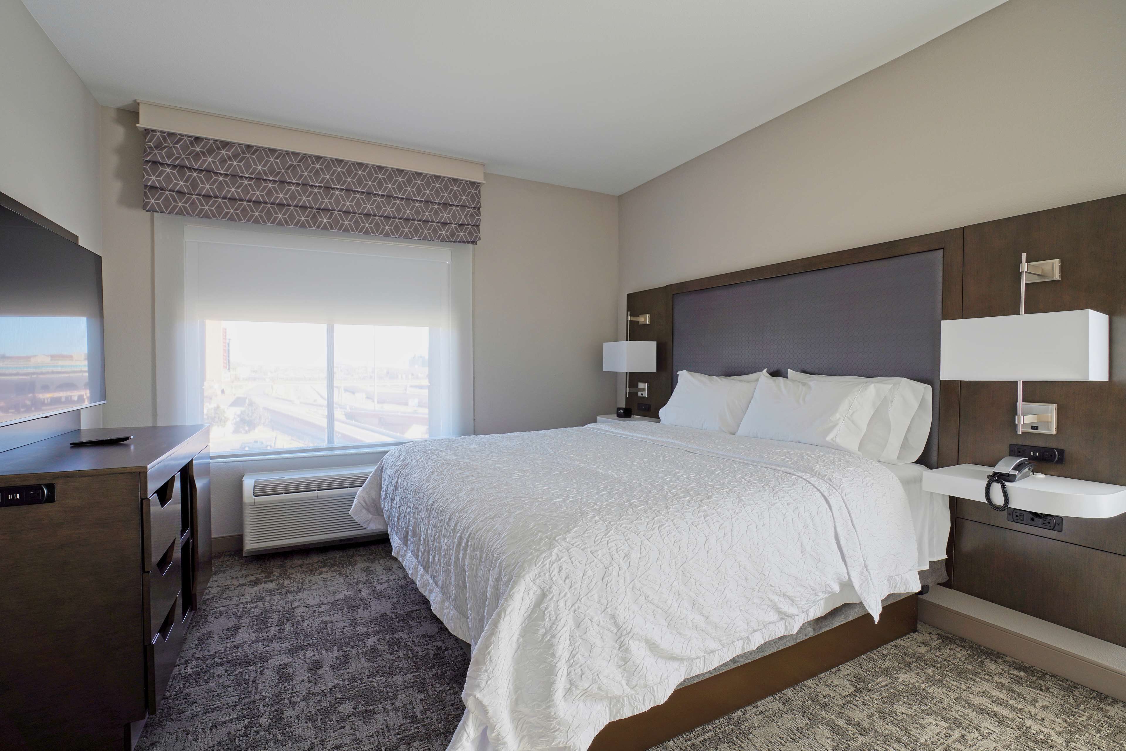 desk, laptop workspace, bed sheets