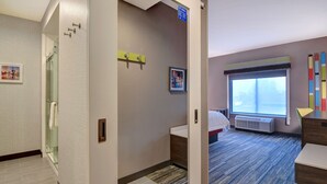 A hotel room with a shower, a bed, a window with a view, and a desk. - Hampton Inn & Suites Canal Winchester Columbus (Canal Winchester)
