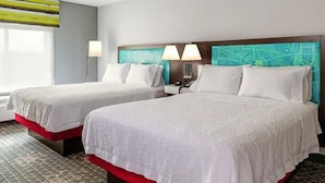 A hotel room with two beds, a nightstand, a lamp, and a large window.