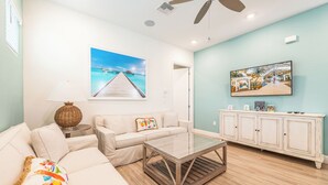 A living room with a sofa, a coffee table, a TV, and a cabinet.