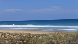 A beach with clear skies and ocean waves.