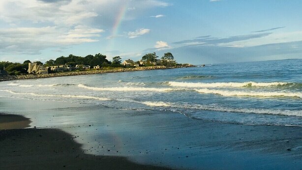 A beach with waves, a rainbow, and houses in the background. - Jenness Beach Ocean Getaway - Book Now for Summer '26! (Rye)