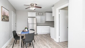 A compact kitchen with white cabinets, a built-in oven, and a ceiling fan. - 🏜Urban Desert Retreat for the Adventurous Traveler Snow Free-Stay with us! ☀️🐾 (Tempe)