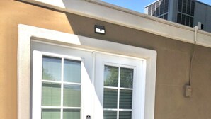 A building with a beige exterior, a white door with a glass panel, and a potted plant beside it. - 🏜Urban Desert Retreat for the Adventurous Traveler Snow Free-Stay with us! ☀️🐾 (Tempe)
