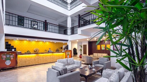 A spacious lobby with a reception desk, multiple seating areas, and a staircase connecting the floors. - The Fern Denzong Hotel & Spa Gangtok (Gangtok)