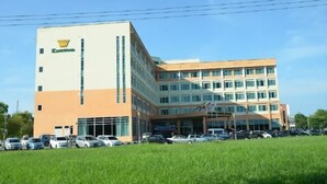 A multi-story building with a prominent logo on the facade.