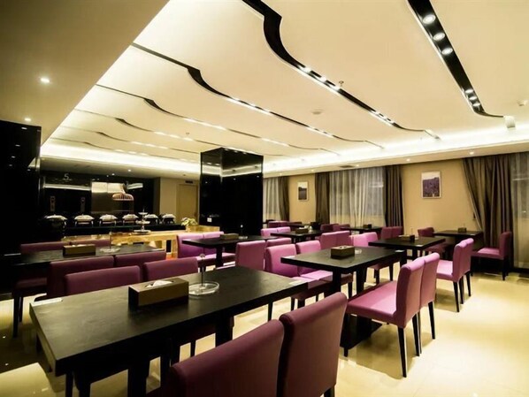 A hotel dining area with multiple tables and chairs, a buffet setup, and a modern ceiling design. - Lavande Hotel (Jiangmen)