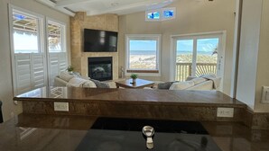 A kitchen with a built-in oven, a large window with a view of the beach, and a seating area with a view of the ocean. - Oceanfront 4 Bedroom 4.5 Bathroom House on A Street St Augustine (St. Augustine)