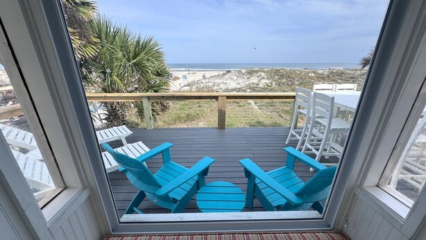 A deck with blue Adirondack chairs and a view of the beach. - Oceanfront 4 Bedroom 4.5 Bathroom House on A Street St Augustine (St. Augustine)