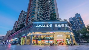A hotel with a modern facade and multiple floors, featuring a prominent sign for 'LAVANDE' and 'LUXURY HOTEL'. - Shenzhen Qianhai Times City Branch of Lavande Hotel (Shenzhen)