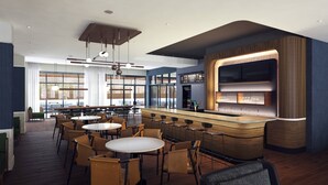 Un restaurante moderno con zona de bar, mesas y sillas redondas.