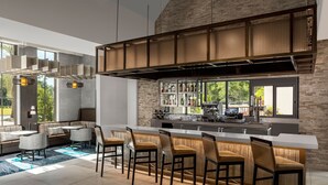 Una cocina moderna con barra, asientos y vistas al exterior.