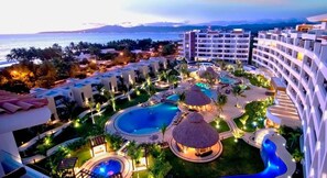 A resort with multiple swimming pools, a central water feature, and a view of the ocean. - Reduced Rate for 2 Bedroom Condo w Ocean View at Luxury Resort in Nuevo Nayarit (Nuevo Vallarta)