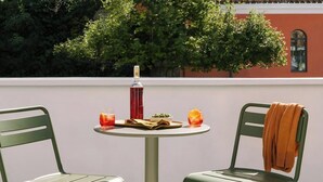 A round table with two chairs, a bottle, and two glasses on it. - Lavande Hotel Shanghai Zhangjiang Guanglan Road Me (Shanghai)
