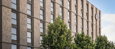 A modern building with a brick facade and multiple windows.