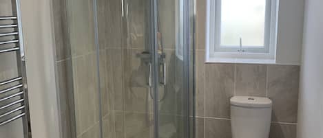 Shower, hair dryer, towels, toilet paper