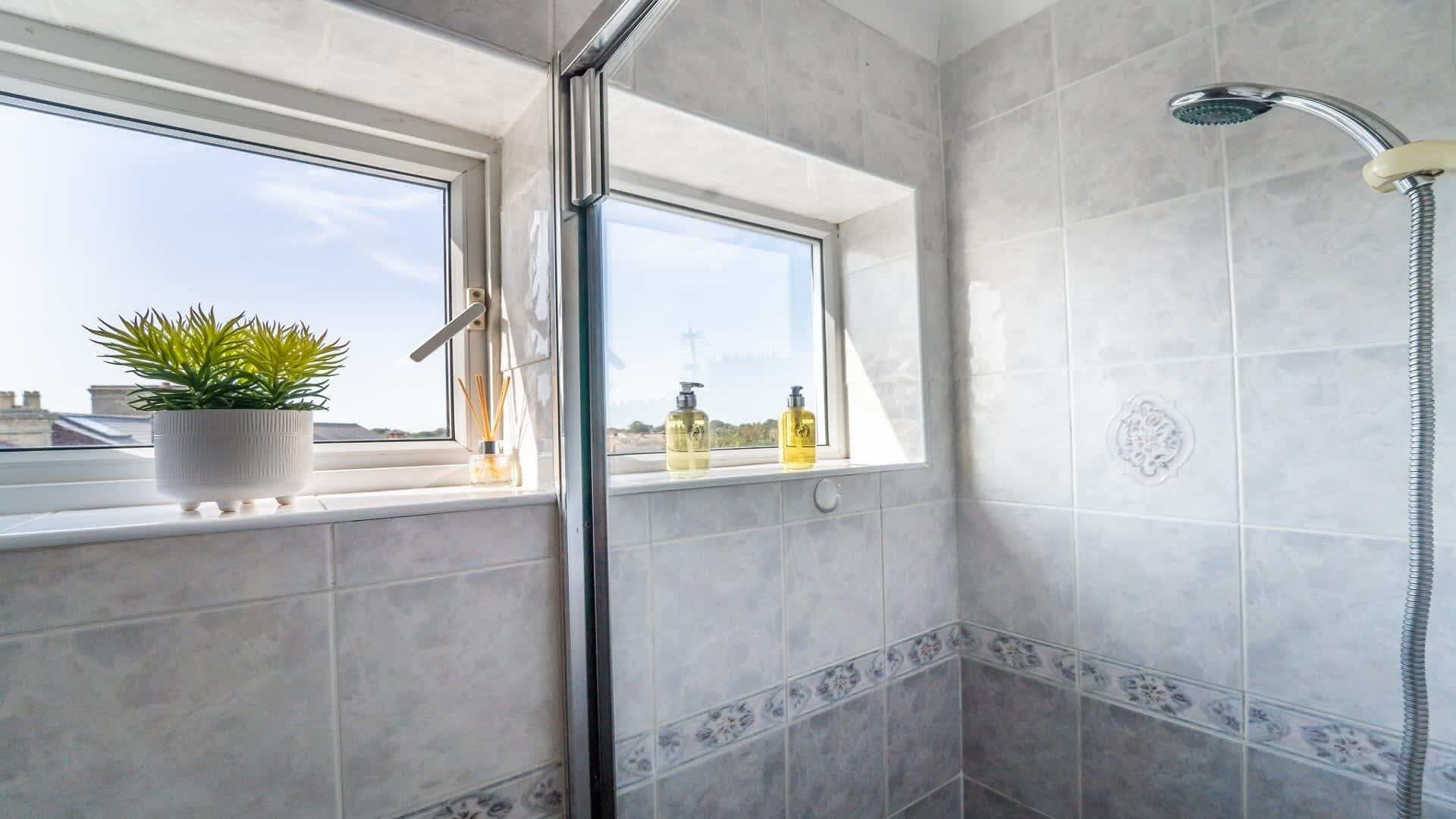 Bathtub, hair dryer, towels, shampoo