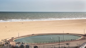A beach with a circular water feature, a promenade, and a view of the sea. - Stunning Sea View Penthouse - 2 Bedroom - 2 Bathr (Gorleston-on-Sea)