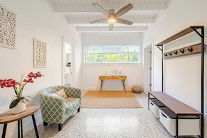 A room with a ceiling fan, a window with blinds, a sofa, a small table, and a bench. - Bright & Spacious 4 mi to BEACH +Big Backyard (Miami)