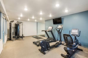 A fitness room with a treadmill, elliptical, and weight machine. - WoodSpring Suites Atlanta Newnan (Newnan)