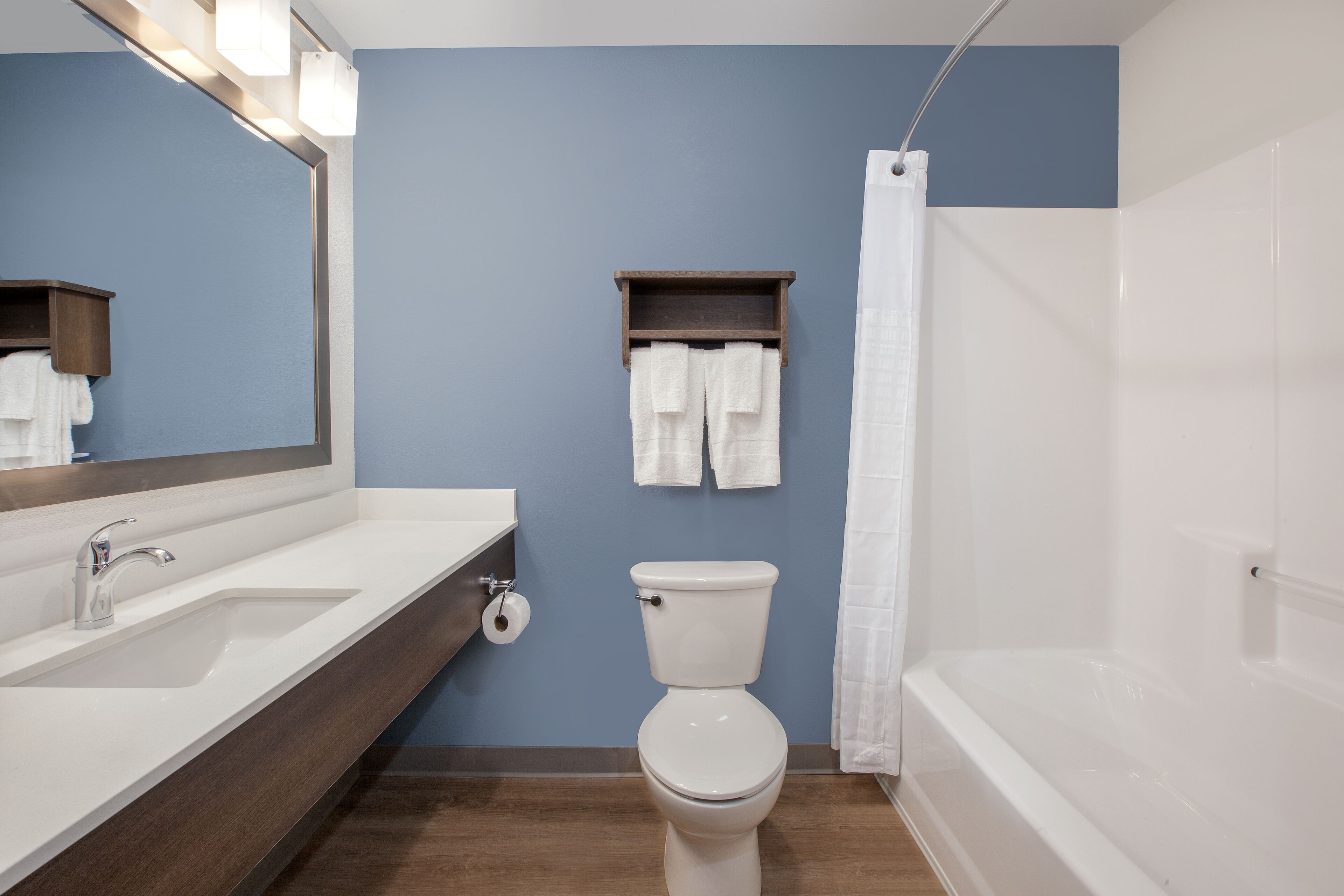 A bathroom with a sink, toilet, and bathtub.