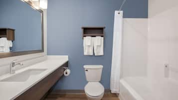 A bathroom with a sink, toilet, and bathtub.