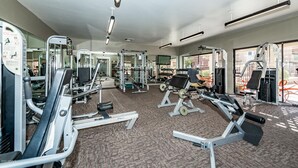 A gym with various exercise equipment, large windows, and a carpeted floor. - Pearl of Scottsdale Old Town Getaway 1BR (Scottsdale)