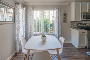 A modern kitchen with white cabinets, a built-in oven, and a microwave. - Pearl of Scottsdale Old Town Getaway 1BR (Scottsdale)