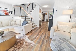 Flat-screen TV, fireplace, books, smart speakers