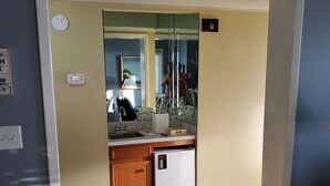 A compact kitchen with a refrigerator, sink, and cabinets. - Direct Oceanfront 3 bedroom 2.5 baths Pelicans Watch unit on popular Shore Drive (Myrtle Beach)