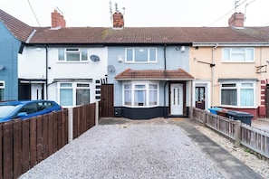 A row of terraced houses with a gravel driveway and a wooden fence. - Spacious House, Garden, Private Parking, Near Hull Uni & Beverley (Kingston upon Hull)