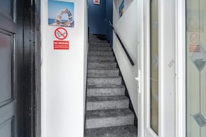 A staircase with a 'NO SMOKING' sign on the wall.
