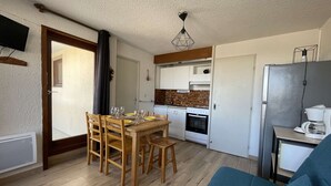 A compact kitchen with a stove, oven, and coffee maker.