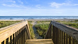 A wooden boardwalk leading to a beach with a clear view of the ocean. - "Sundance" - Oceanfront Home w/ Private Pool, 5 Bedrooms / 4.5 Bathrooms (Holden Beach)