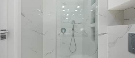 Shower, hair dryer, towels, shampoo