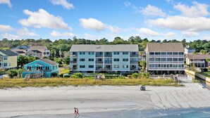 A beachfront hotel with multiple-story buildings, a sandy beach, and ocean views. - Condo w/ Private Balcony & Stunning Beach Views (Surfside Beach)
