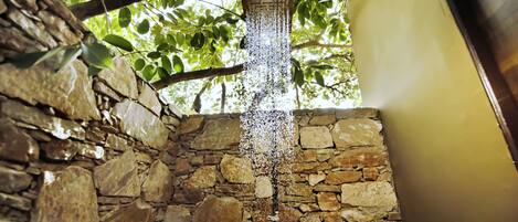 A stone wall with a water feature.