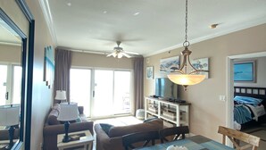 A dining area with a wooden table, chairs, and a ceiling fan.
