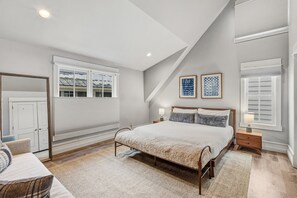 A bedroom with a bed, bedside tables, a chair, and a window with blinds. - 4BR Telluride Mountain Home | Hot Tub & Private Deck | Walk to Ski & Downtown (Telluride)