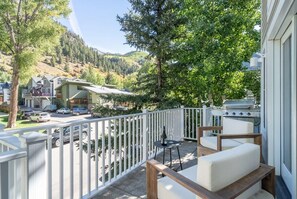 A balcony with outdoor seating, a grill, and a view of a hilly landscape. - 4BR Telluride Mountain Home | Hot Tub & Private Deck | Walk to Ski & Downtown (Telluride)