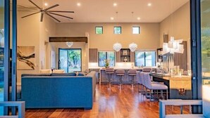 A modern interior with a living area, kitchen, and dining space. - Arcadia Luxury 4 Bedroom 4EnSuite Bath Heated Pool (Phoenix)
