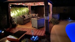 A gazebo with outdoor seating, string lights, and a pool. - Central location with all the right amenities for the perfect vacation. (Tucson)