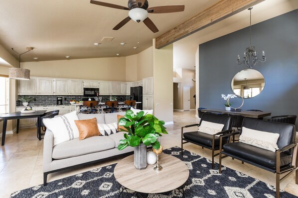 Relax in this open-plan living space with a sofa set, coffee table, and dining table.