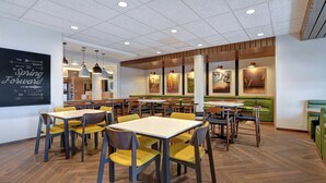 A restaurant with multiple tables and booths, wooden flooring, and a ceiling with recessed lighting. - Fairfield Inn & Suites by Marriott Selinsgrove (Selinsgrove)