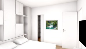 A modern bedroom with a large bed, built-in wardrobe, and a door leading to a bathroom.